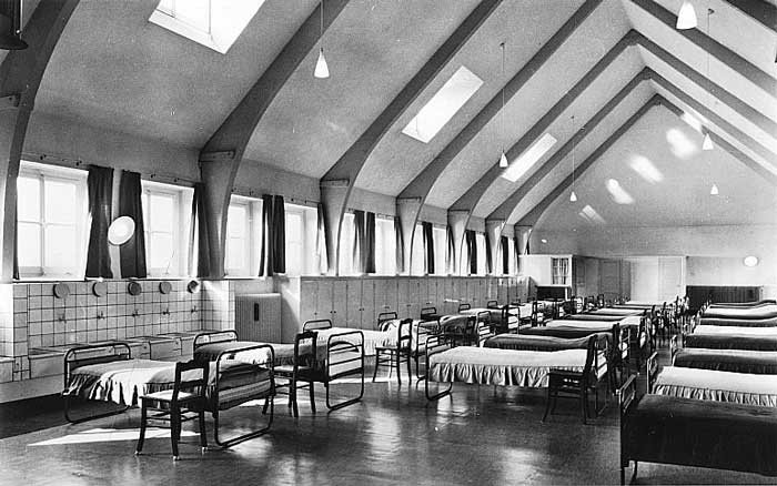 Open slaapzaal van het internaat, met klerenkasten en wasbakken, 1955 (bron: Erfgoedcentrum Nederlands Kloosterleven, coll. Broeders van de Christelijke Scholen, nr. 194247)
